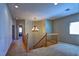 Well-lit staircase with decorative chandelier and neutral color scheme at 9209 Tudor Park Pl, Las Vegas, NV 89145