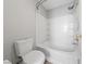 Full bathroom features a shower-tub combo with white tile surround and built-in shelving at 9312 Straw Hays St # 103, Las Vegas, NV 89178