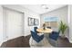 A staged dining room featuring a round table with blue chairs on a carpeted floor area at 9312 Straw Hays St # 103, Las Vegas, NV 89178