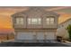 A home's front exterior with three garage doors below and three visible windows above at 9312 Straw Hays St # 103, Las Vegas, NV 89178