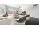 Staged living room with neutral walls, dark floors, and patio access at 9312 Straw Hays St # 103, Las Vegas, NV 89178