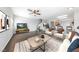 Staged living room offering a view of the kitchen with barstool seating and neutral-colored decor at 9312 Straw Hays St # 103, Las Vegas, NV 89178
