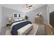 Bright main bedroom is complete with ceiling fan, TV and an adjacent window overlooking the landscaped outdoors at 9312 Straw Hays St # 103, Las Vegas, NV 89178
