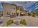 A backyard with patio, desert landscaping, and two story house at 9792 Crescent Lodge Ct, Las Vegas, NV 89178
