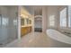 Bright and airy bathroom showcasing a soaking tub and a glass-enclosed shower at 9792 Crescent Lodge Ct, Las Vegas, NV 89178