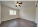Bedroom with wood-look floors, ceiling fan, and window with white shutters at 9792 Crescent Lodge Ct, Las Vegas, NV 89178