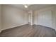 Bedroom with wood-look floors and double door closet at 9792 Crescent Lodge Ct, Las Vegas, NV 89178