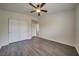 Bedroom with wood-look floors and double door closet at 9792 Crescent Lodge Ct, Las Vegas, NV 89178