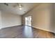 Spacious bedroom with dark hardwood floors and sliding glass doors to private balcony at 9792 Crescent Lodge Ct, Las Vegas, NV 89178