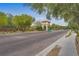 Community entrance with paved brick road, guardhouse, and mature landscaping at 9792 Crescent Lodge Ct, Las Vegas, NV 89178