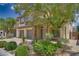 Well-manicured two-story home boasts beautiful landscaping, a stone facade, and a three-car garage at 9792 Crescent Lodge Ct, Las Vegas, NV 89178