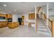 Open kitchen and staircase featuring wood cabinets, granite counters, and modern appliances at 9792 Crescent Lodge Ct, Las Vegas, NV 89178