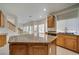 Inviting kitchen featuring granite counters, wood cabinets, and modern sink fixtures at 9792 Crescent Lodge Ct, Las Vegas, NV 89178
