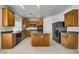 Modern kitchen featuring granite countertops, maple cabinets, stainless steel appliances, and a large island at 9792 Crescent Lodge Ct, Las Vegas, NV 89178