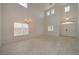 Bright and airy living room featuring tile floors, a double front door, lots of windows, and neutral paint at 9792 Crescent Lodge Ct, Las Vegas, NV 89178