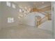 Open-concept living room with wood-look floors, high ceilings, staircase, and abundant natural light at 9792 Crescent Lodge Ct, Las Vegas, NV 89178