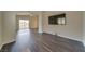 Open concept with hardwood floors, a wall-mounted TV, and a view of the patio at 9792 Crescent Lodge Ct, Las Vegas, NV 89178