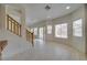 Bright living room featuring tile flooring, large windows, and sliding door to backyard at 9792 Crescent Lodge Ct, Las Vegas, NV 89178
