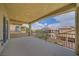A covered patio area featuring views of neighboring homes and a decorative railing at 9792 Crescent Lodge Ct, Las Vegas, NV 89178