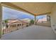 A covered patio area featuring views of neighboring homes and a decorative railing at 9792 Crescent Lodge Ct, Las Vegas, NV 89178