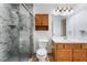 Full bathroom featuring updated shower, oak vanity, and modern fixtures at 9962 Keephills St, Las Vegas, NV 89183