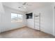 Carpeted bedroom featuring ceiling fan, shelving and window views at 9962 Keephills St, Las Vegas, NV 89183