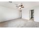 Large bedroom with neutral carpeting, a ceiling fan, and an ensuite bathroom at 9962 Keephills St, Las Vegas, NV 89183