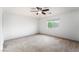 Bright bedroom featuring large window, neutral carpeting, and ceiling fan at 9962 Keephills St, Las Vegas, NV 89183