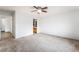 Spacious bedroom with neutral carpet and ceiling fan, adjoining a bathroom with oak vanity at 9962 Keephills St, Las Vegas, NV 89183