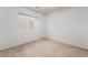 Bright, carpeted bedroom featuring a window and ceiling fan at 9962 Keephills St, Las Vegas, NV 89183