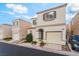 Charming two-story home featuring a tan exterior, well-kept landscaping, and an attached garage at 9962 Keephills St, Las Vegas, NV 89183