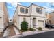 Charming two-story home featuring a tan exterior, well-kept landscaping, and an attached garage at 9962 Keephills St, Las Vegas, NV 89183