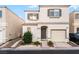 Charming two-story home featuring a tan exterior, well-kept landscaping, and an attached garage at 9962 Keephills St, Las Vegas, NV 89183