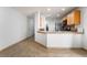 Bright kitchen featuring a breakfast bar, stainless steel appliances, and tile floors at 9962 Keephills St, Las Vegas, NV 89183