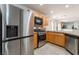 Modern kitchen showcasing stainless steel appliances and wooden cabinetry at 9962 Keephills St, Las Vegas, NV 89183