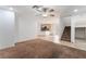 Open-concept living area with tile and carpet floors, adjoining the kitchen, and staircase at 9962 Keephills St, Las Vegas, NV 89183