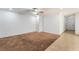Spacious living room featuring a ceiling fan, plush carpeting, and ample natural light at 9962 Keephills St, Las Vegas, NV 89183