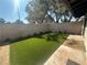A backyard with fresh green turf and some landscaping by the block wall at , Las Vegas, NV 89121