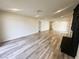 Bright, open living room featuring new gray wood-look floors and fresh, neutral paint at , Las Vegas, NV 89121