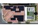 Aerial view of a home with solar panels, showcasing a backyard oasis with fire pit, jacuzzi and manicured lawn at 10300 Stroma Ave, Las Vegas, NV 89166