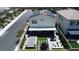 Aerial shot of a home highlighting the backyard featuring a covered patio, fire pit, jacuzzi, and lush landscaping at 10300 Stroma Ave, Las Vegas, NV 89166