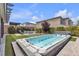 Lush backyard featuring a jacuzzi, stone fire pit, and artificial turf, perfect for outdoor enjoyment at 10300 Stroma Ave, Las Vegas, NV 89166