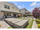 Well-maintained backyard with covered patio, fire pit area, jacuzzi, and manicured lawn, ideal for leisure at 10300 Stroma Ave, Las Vegas, NV 89166