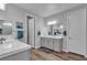 Bathroom featuring double sinks, quartz countertops, framed mirrors, and modern fixtures at 10300 Stroma Ave, Las Vegas, NV 89166