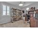 Bright bedroom with shelves for display, shutters, and an office area at 10300 Stroma Ave, Las Vegas, NV 89166