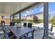 Spacious covered patio with dining area and view of a backyard with fire pit and in-ground jacuzzi at 10300 Stroma Ave, Las Vegas, NV 89166