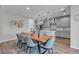 Open dining area flows to a modern kitchen, featuring stylish furnishings and natural light, creating a welcoming atmosphere at 10300 Stroma Ave, Las Vegas, NV 89166