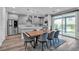 Open concept dining room with stylish table, modern lighting, and seamless flow to the outdoor patio at 10300 Stroma Ave, Las Vegas, NV 89166