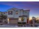 Charming two-story home showcasing its architectural design and well-manicured front yard at dusk at 10300 Stroma Ave, Las Vegas, NV 89166