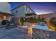 Backyard space featuring a stone fire pit, comfortable seating, and ambient lighting perfect for outdoor entertainment at 10300 Stroma Ave, Las Vegas, NV 89166